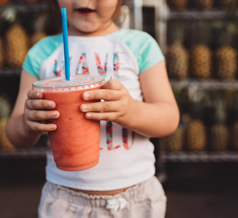 A toddler happily eating vegetables, a goal of our toddler nutrition and healthy eating workshops.